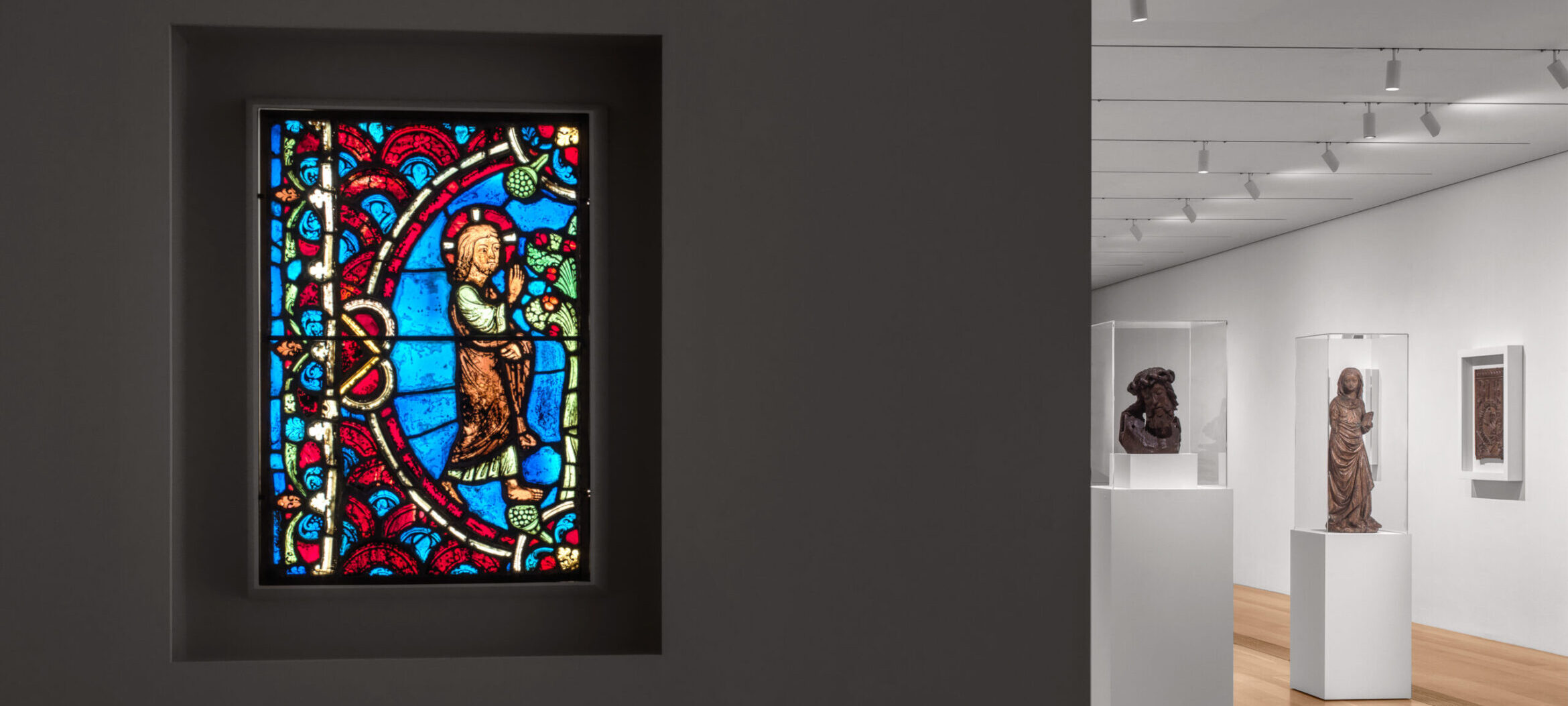Photo of stained glass and exhibit room for Pulitzer Arts Foundation's Current Exhibition The Nature of Things: Medieval Art and Ecology, 1100-1550